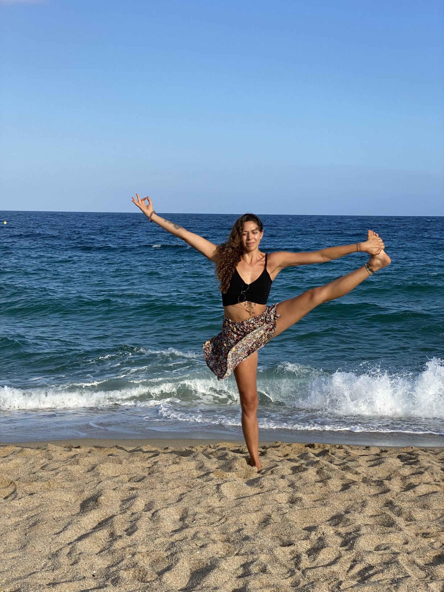 Ceci doing yoga posture on the beach
