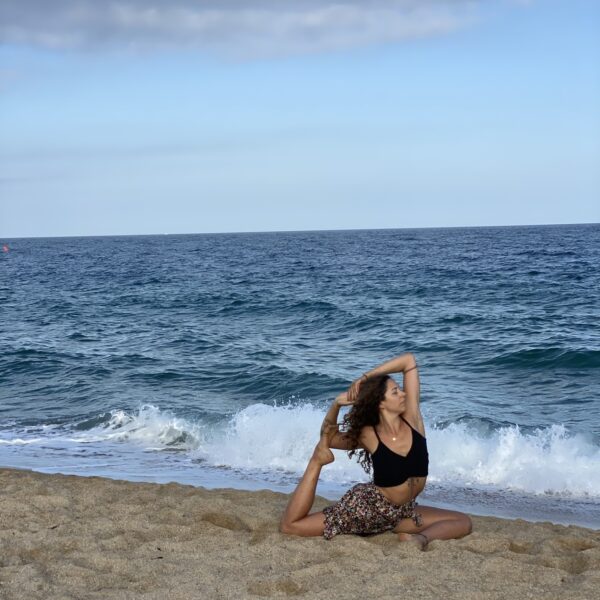 Ceci doing yoga on the beach